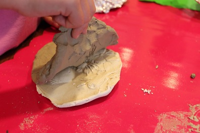 Peeling the clay off the homemade fossil